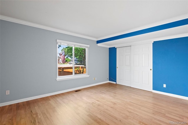 6846 Edgewood Way, Highlands Ranch, CO 80130 - unfurnished bedroom with wood finished floors, crown molding, and a closet
