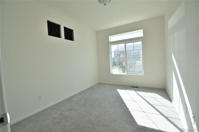 spare room with light colored carpet