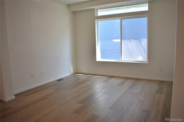 spare room featuring light wood-type flooring