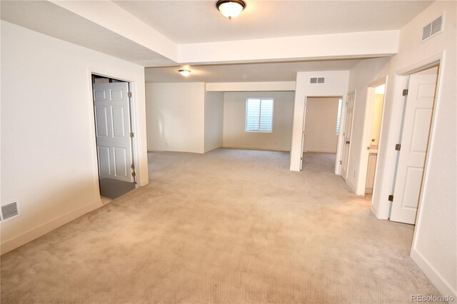 basement featuring light carpet