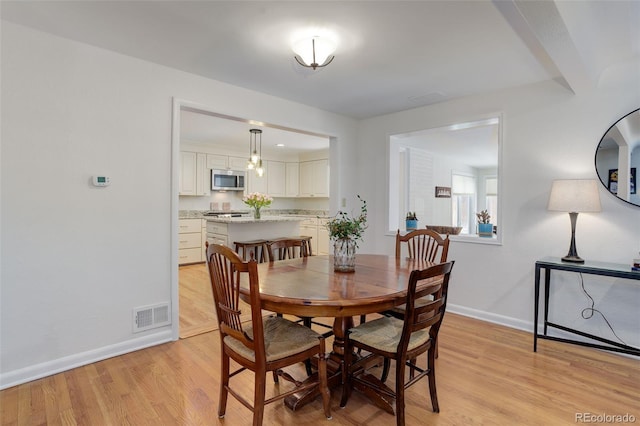 3090 S High St, Denver, CO 80210 - dining space with baseboards and light wood-style flooring