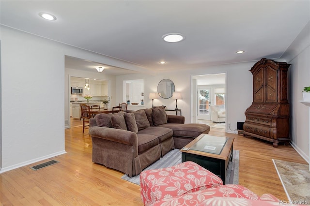 3090 S High St, Denver, CO 80210 - living area with light wood-style flooring, recessed lighting, and baseboards