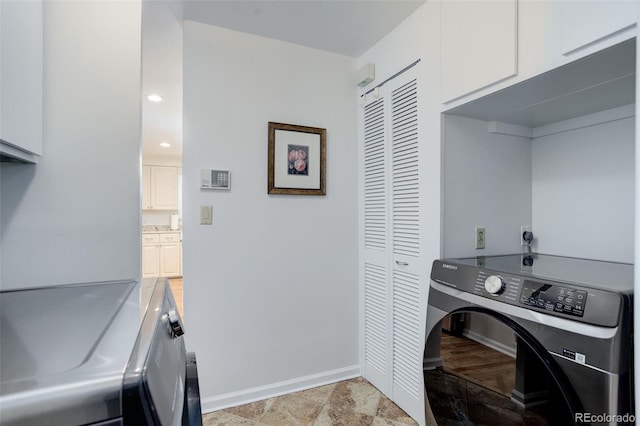 3090 S High St, Denver, CO 80210 - washroom featuring washing machine and clothes dryer, cabinet space, and baseboards