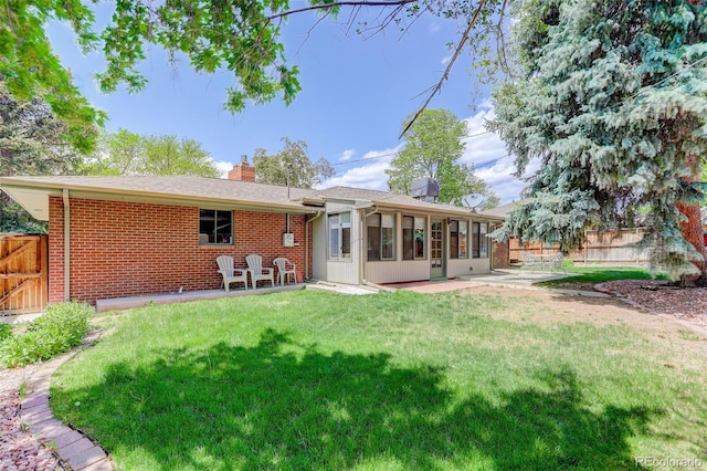3090 S High St, Denver, CO 80210 - rear view of house featuring a chimney, a sunroom, brick siding, a patio area, and a gate