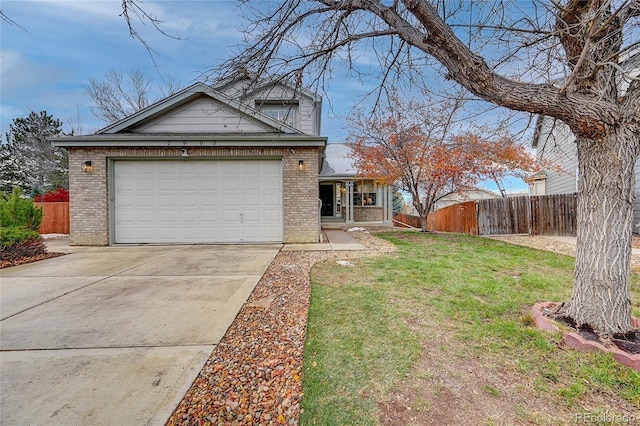 view of front of property featuring a front yard and a garage