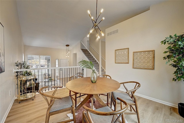 dining room featuring light hardwood / wood-style floors and an inviting chandelier