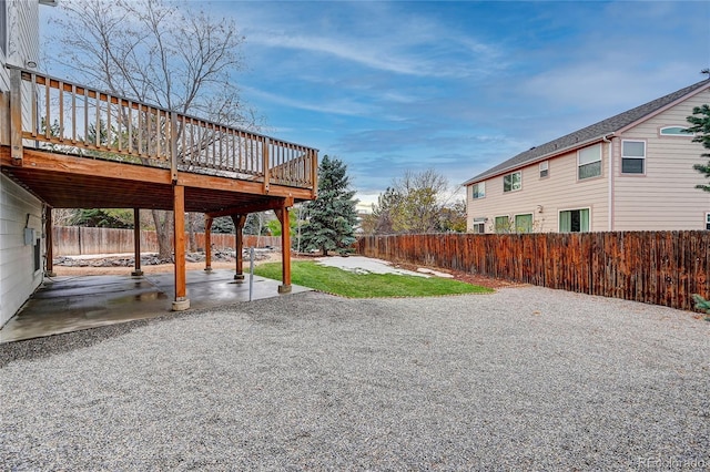 view of yard with a patio area and a wooden deck