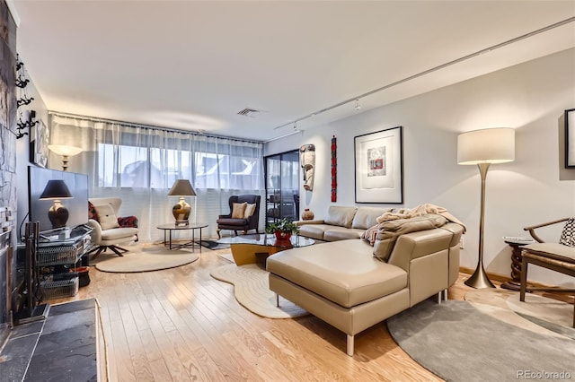 living room featuring track lighting and hardwood / wood-style flooring