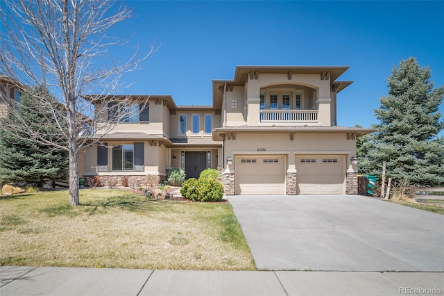 view of front of house featuring a balcony, a garage, and a front yard