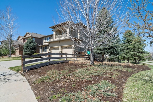 view of front of home featuring a balcony and a garage