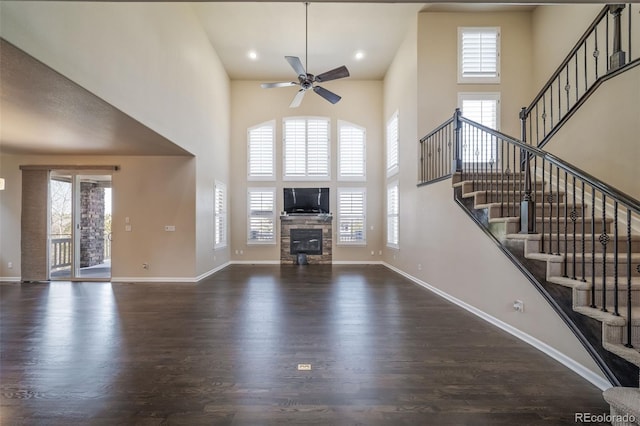 entrance foyer with ceiling fan, plenty of natural light, dark wood-type flooring, and a high ceiling