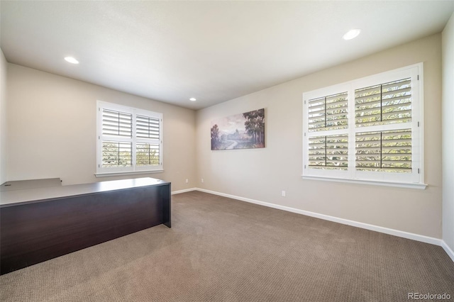 unfurnished office with dark colored carpet