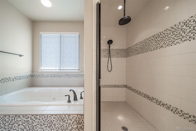 bathroom featuring a healthy amount of sunlight and shower with separate bathtub