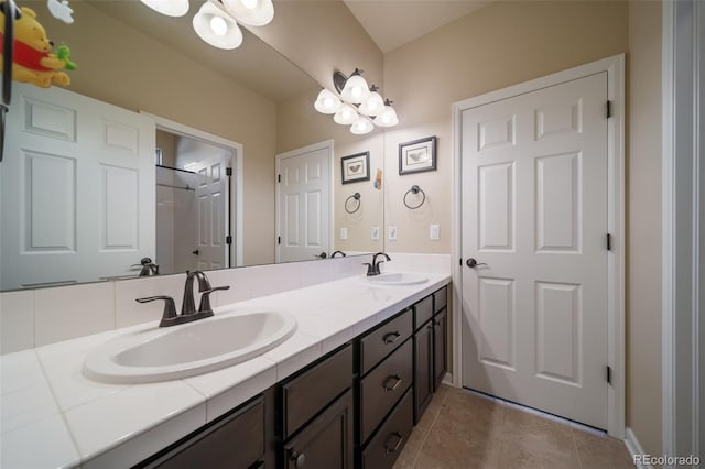 bathroom featuring tile flooring, dual sinks, and vanity with extensive cabinet space