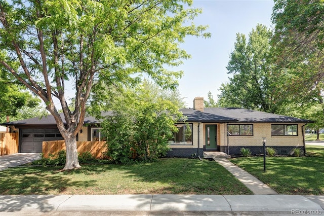 1695 E Eastman Ave, Englewood, CO 80113 - view of front of home with brick siding, a chimney, an attached garage, and driveway