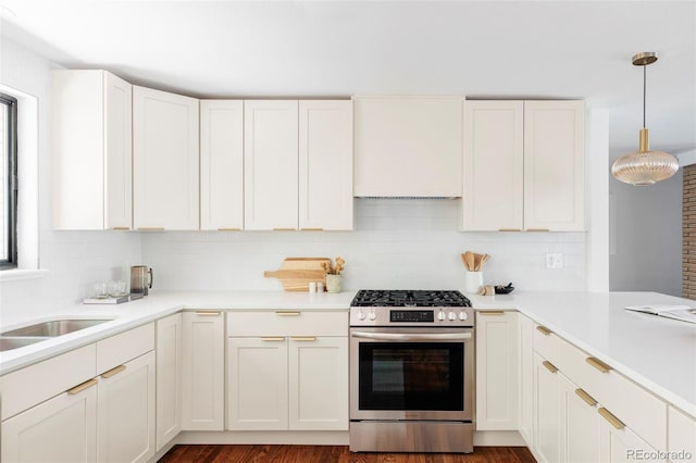 1695 E Eastman Ave, Englewood, CO 80113 - kitchen with stainless steel gas range, backsplash, light countertops, and decorative light fixtures