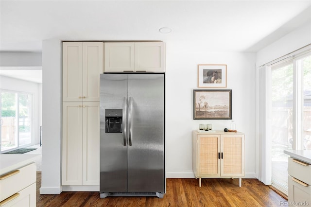 1695 E Eastman Ave, Englewood, CO 80113 - kitchen featuring stainless steel fridge, dark wood-type flooring, light countertops, baseboards, and white cabinets
