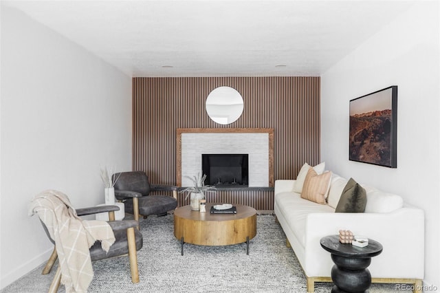 1695 E Eastman Ave, Englewood, CO 80113 - carpeted living area with baseboards, a fireplace, and an accent wall