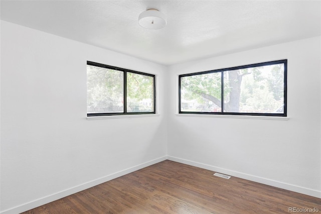 1695 E Eastman Ave, Englewood, CO 80113 - spare room with baseboards and dark wood finished floors