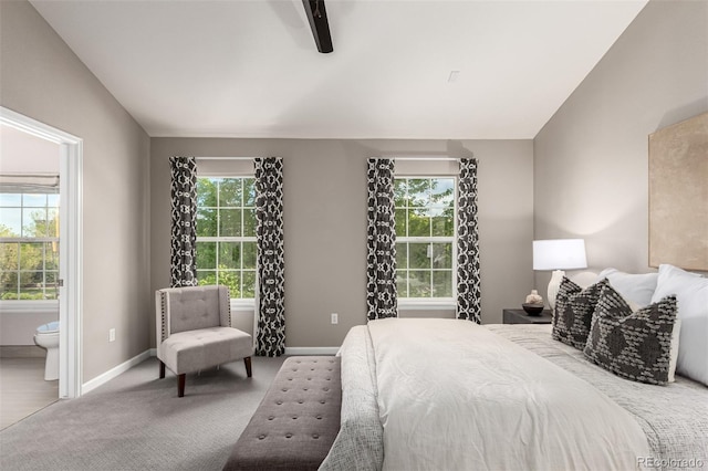 carpeted bedroom featuring baseboards, connected bathroom, ceiling fan, and vaulted ceiling