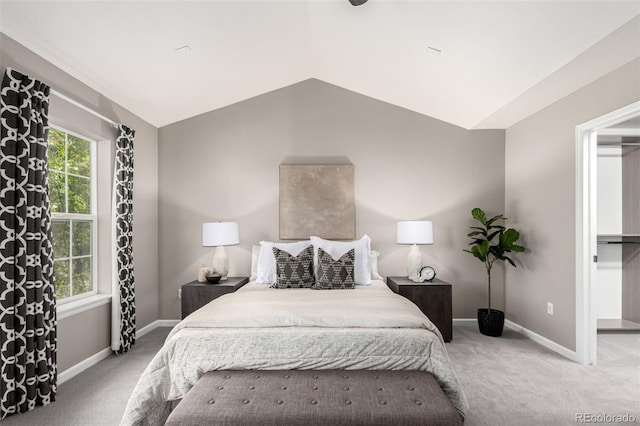 bedroom featuring carpet, lofted ceiling, multiple windows, and baseboards