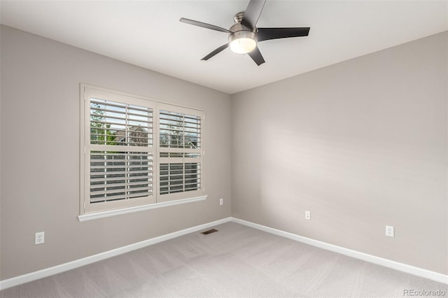 unfurnished room featuring baseboards, ceiling fan, and carpet flooring