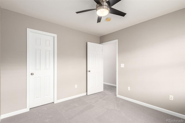 unfurnished bedroom featuring carpet flooring, baseboards, and a ceiling fan