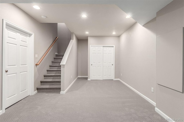 basement featuring carpet floors, baseboards, recessed lighting, and stairway