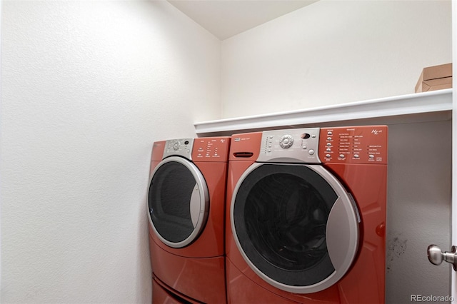 clothes washing area featuring washing machine and clothes dryer