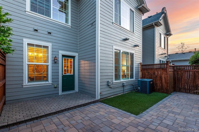 view of patio featuring central air condition unit and fence