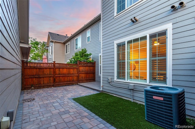 view of yard featuring central AC, a patio area, and fence