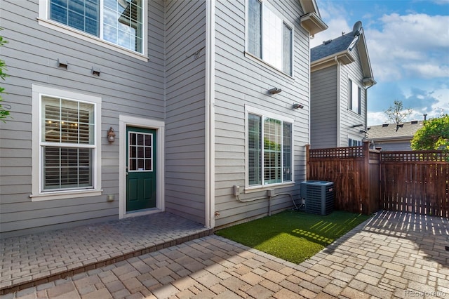 view of patio with central AC and fence