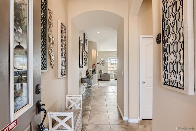 hall with light tile patterned floors