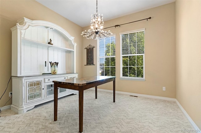 office space with light colored carpet and a chandelier