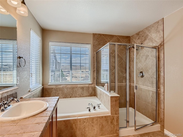 bathroom with tile patterned floors, a wealth of natural light, sink, and independent shower and bath