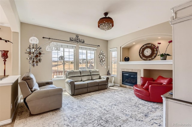 living room featuring a tiled fireplace