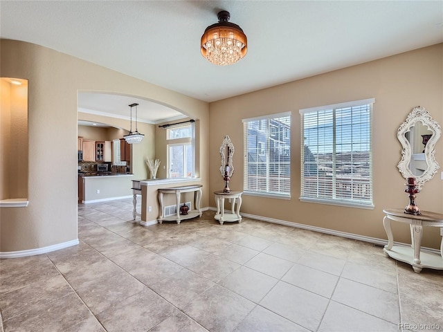 sitting room featuring light tile patterned floors and an inviting chandelier