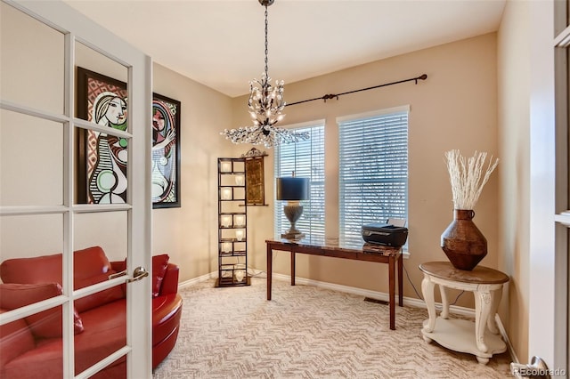 office space featuring a chandelier, french doors, and carpet flooring