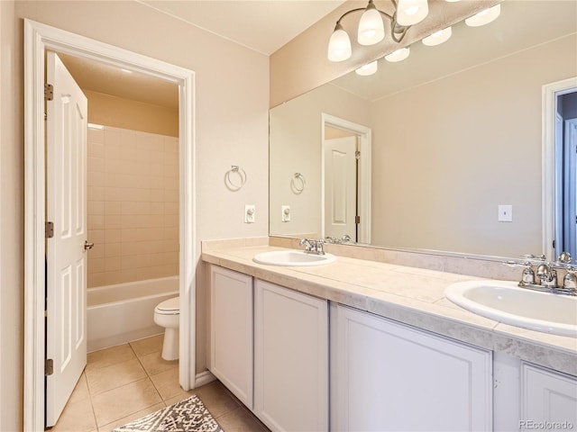 full bathroom featuring tiled shower / bath, tile patterned flooring, vanity, and toilet