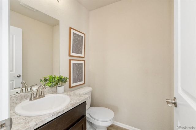 bathroom with toilet and vanity