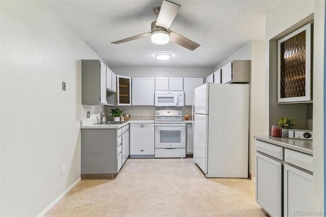 9385 E Center Ave Unit 6A, Denver, CO 80247 - kitchen with white appliances, a sink, a ceiling fan, a textured ceiling, and light countertops