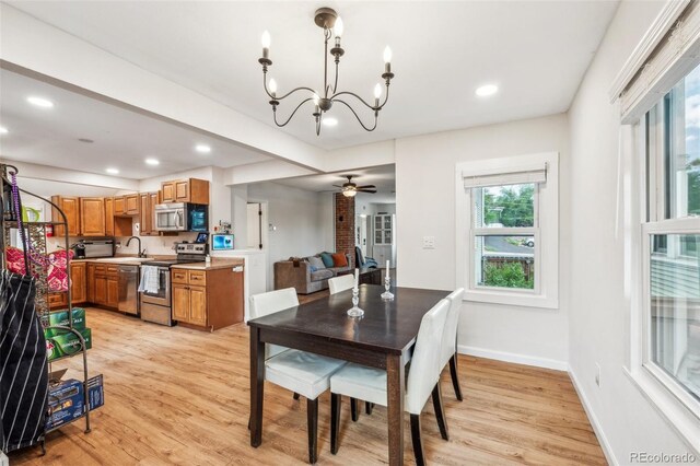dining space featuring a chandelier, healthy amount of natural light, light wood-type flooring, and recessed lighting