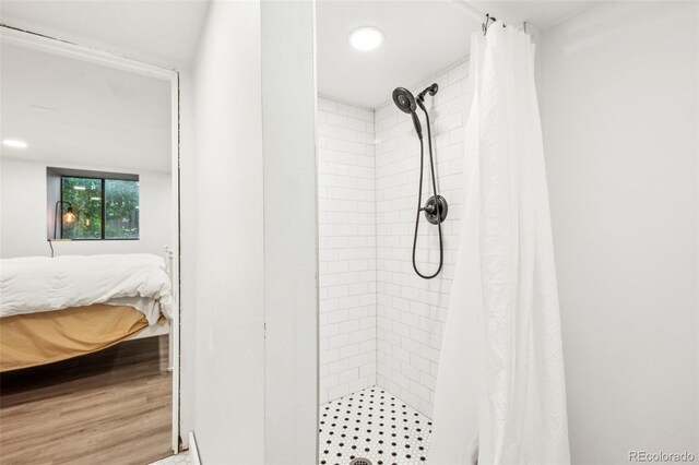 ensuite bathroom with a shower stall and recessed lighting