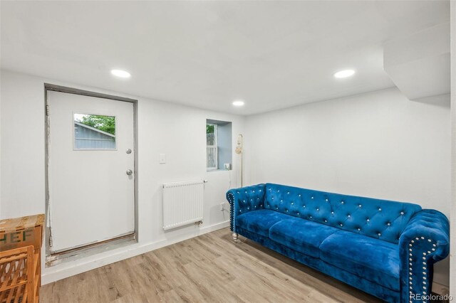 sitting room featuring radiator heating unit, wood finished floors, plenty of natural light, and recessed lighting