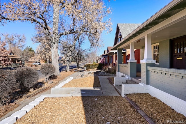 view of yard featuring covered porch