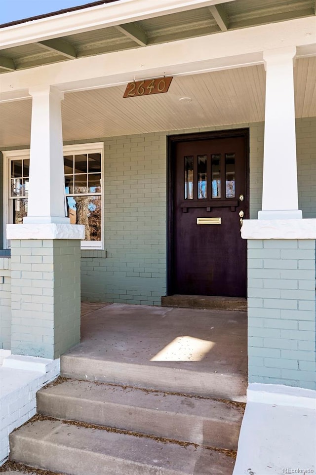 view of exterior entry with covered porch