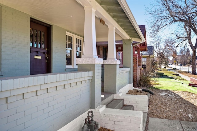 view of exterior entry featuring a porch