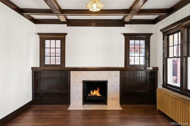 unfurnished living room featuring radiator, beamed ceiling, and coffered ceiling