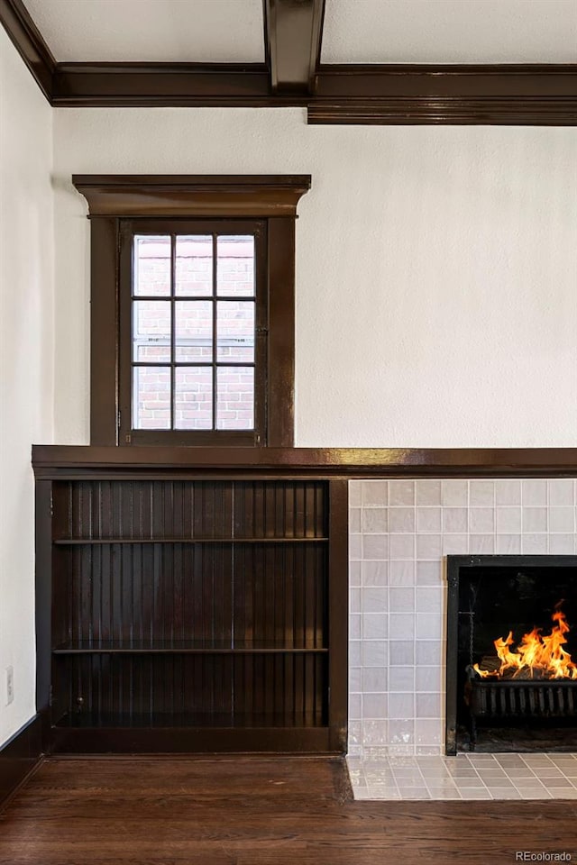 room details with a fireplace, ornamental molding, and hardwood / wood-style flooring