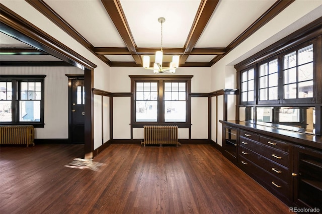 entryway with coffered ceiling, a notable chandelier, radiator heating unit, and dark hardwood / wood-style floors